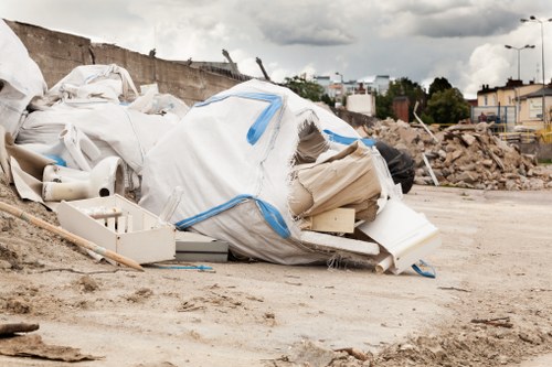 A skip being loaded with construction debris and waste materials.