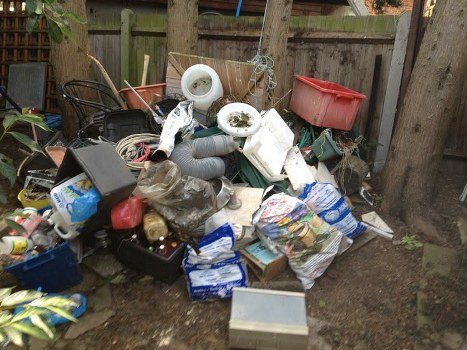 Skip truck delivering a skip to a Walthamstow residential area